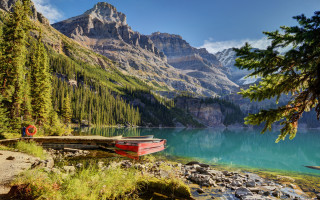 Rocky shore mountain lake boat - naturalism free wallpaper
