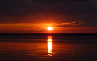 Sunset water boat clouds horizon 2 - a boat in the distance free wallpaper