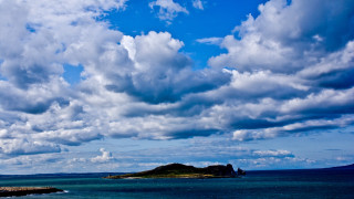 Boat island water cloudy sky - a small island in the distance free wallpaper