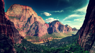 Scenic valley mountains clouds trees - a scenic view of a valley free wallpaper