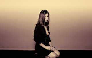 Woman sitting blackdress heels crossed - a black dress and heels free wallpaper