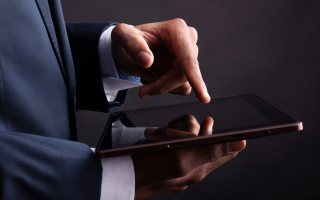 Man in suit holding tablet - his finger free wallpaper