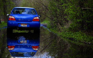 Blue car parked reflections forest - a blue car free wallpaper