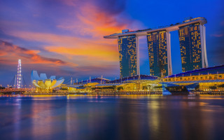 Sunset cityscape water bridge skyscraper - a boat in the foreground free wallpaper