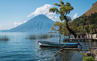 Mountain lake dock boat tree - a tree in the foreground free wallpaper