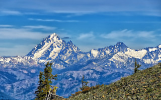 Mountain range snow capped trees - a mountain range free wallpaper