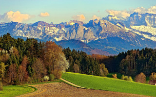 Mountain field road sunset cloudy - a scenic view of a mountain range free wallpaper