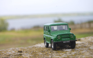 Green toy truck rock water - a grassy area free wallpaper