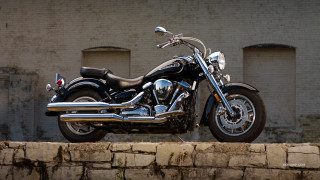 Motorcycle parked stone wall brick - chrome free wallpaper