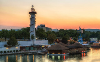 Lighthouse sunset harbor boats pier - a lighthouse free wallpaper