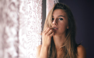 Woman window curtain portrait blonde - a curtain behind her free wallpaper