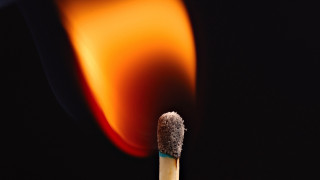 Matchstick lit flame dark background - a matchstick free wallpaper