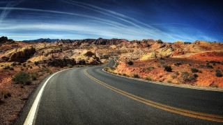 Desert curved road mountain sky - a sky background and a mountain range in the distance free wallpaper