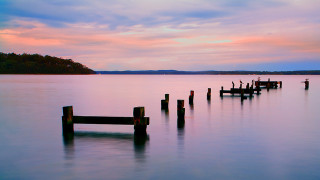Wooden posts lake sunset boat - the middle of a lake free wallpaper