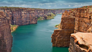 Large water rocky cliffs boat - a large body of water free wallpaper