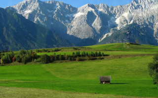 Green field house mountains nature - a house in the middle of it free wallpaper