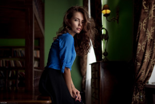 Woman blue shirt leaning table - a table in a room free wallpaper