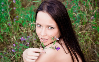 Woman flower field green eyes - long hair and a flower free wallpaper