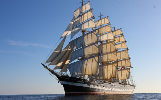 Large sailboat ocean sunny day - a few cloud free wallpaper