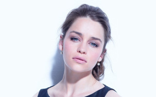 Woman black dress blue eyes 2 - a white wall free wallpaper