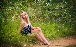 Woman sitting grass nature blue - her leg free wallpaper