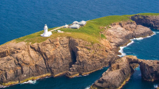 Lighthouse island ocean aerial view - a small island in the middle of the ocean free wallpaper