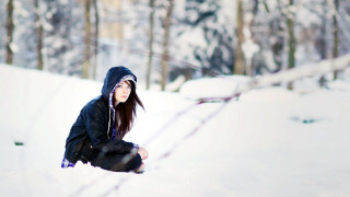 Woman squatting snow trees fence - a black jacket free wallpaper