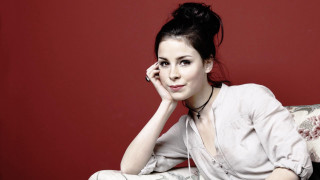 Woman couch red wall portrait - a red wall behind her free wallpaper