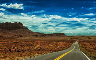 Mountain road ocean sky clouds - a long road free wallpaper