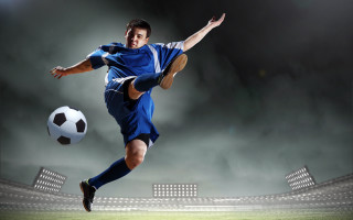 Man kicking soccer stadium dirt - a stadium in the background free wallpaper