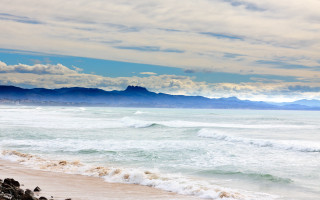Beach surfboard mountains clouds sky - beautiful landscape free wallpaper for desktop