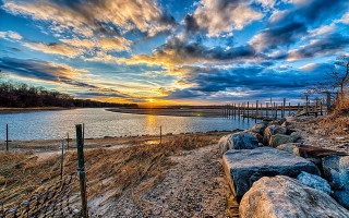 Sunset water shore rocks fence - rock free wallpaper