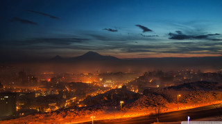 City skyline night mountain background - a foggy sky above free wallpaper