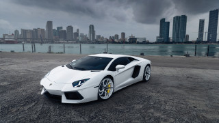 White sports car city skyline 2 - a dark cloud in the sky above free wallpaper