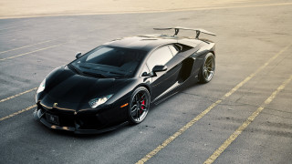 Black sports car surfboard parking - a parking lot free wallpaper