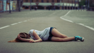 Woman laying street denim shorts - the middle of a street free wallpaper