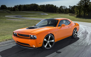 Bright orange car green field - a road next free wallpaper