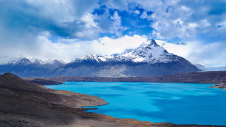 Mountain lake snow capped clouds - mountain in the background free wallpaper