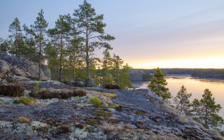 Rocky cliff lake sunset trees - akseli gallenkallela free wallpaper