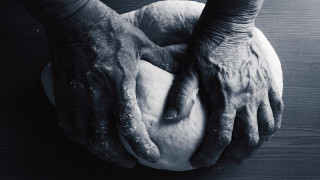 Doughnut hands wooden table blackwhite - a person holding free wallpaper