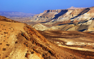 Mountain range blue sky brown - a view of a mountain range free wallpaper