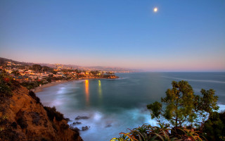 City ocean cliff moon scene - a full moon in the sky free wallpaper
