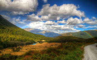 Scenic valley rainbow river landscape - a scenic view of a valley free wallpaper
