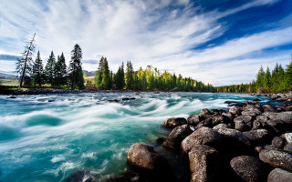 River rocks trees clouds mountains - a mountain in the distance free wallpaper