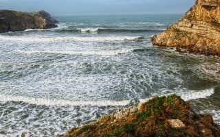 Wave riders beach cliff ocean - a cliff face free wallpaper