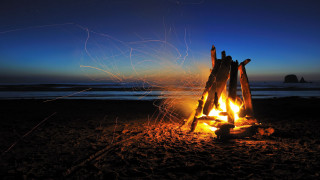 Campfire beach rock formation sunset - a rock formation in the foreground free wallpaper