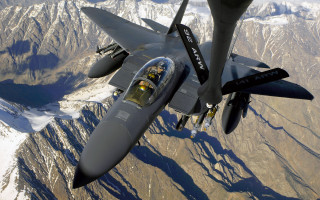 Fighter jet mountain range pilot - over a mountain range in the sky free wallpaper