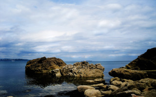 Person rock water boat sky - a boat in the distance free wallpaper