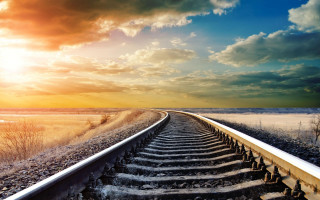Train track sunset clouds cityscape 2 - a sun setting behind free wallpaper