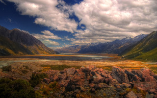 Mountain valley lake rocks grass - a mountain valley free wallpaper